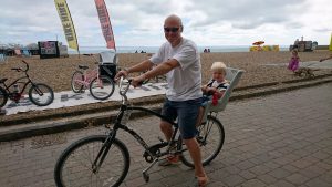 Child seat and bike on beach